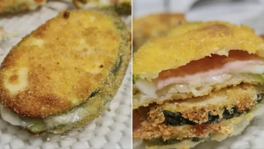 Involtini di zucchine croccanti con cuore di prosciutto e provola filante, cotti in friggitrice ad aria, serviti su un piatto con una spruzzata di olio